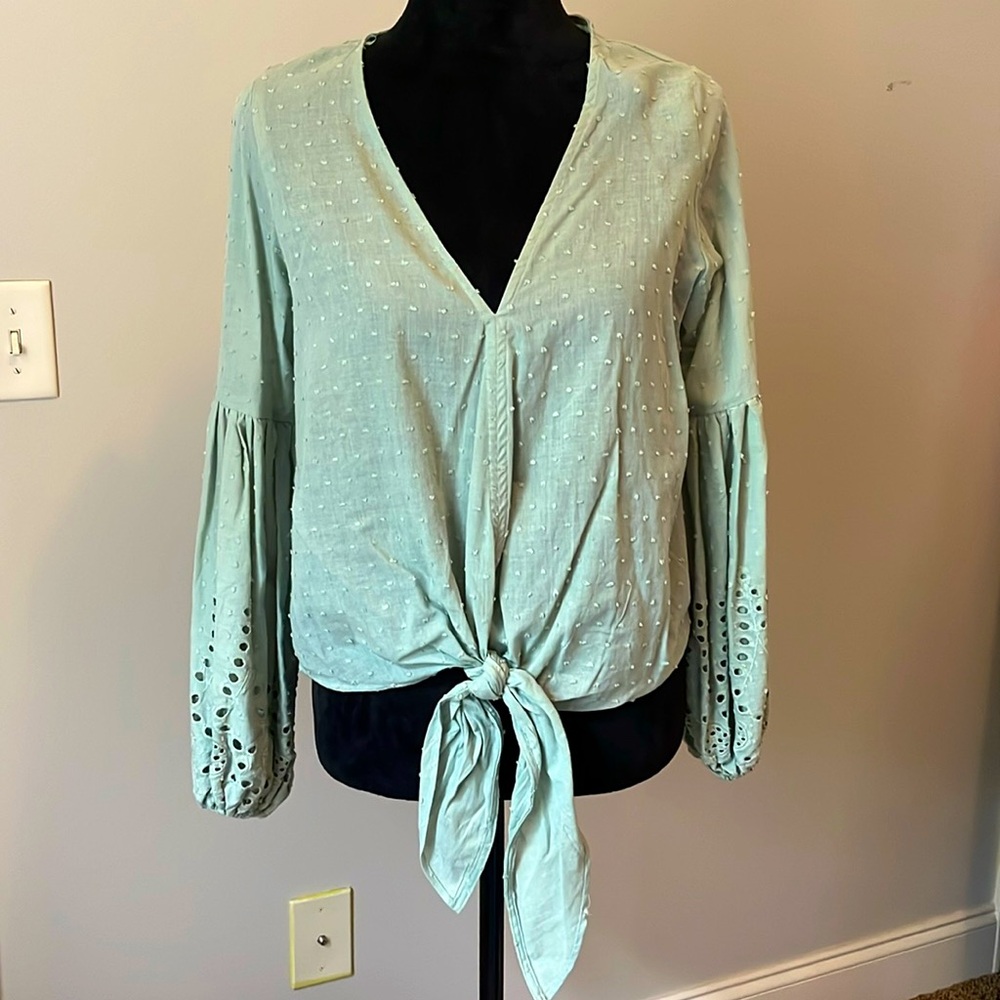 Sage green blouse with eyelet sleeve detail.